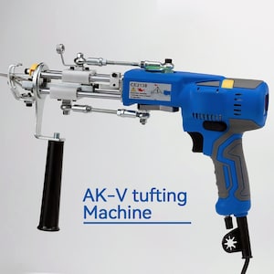 May include: A blue and gray electric tufting machine with a black handle and a foot pedal. The machine has a label that says "AK-V tufting Machine".