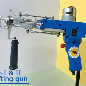 May include: A blue and silver TD-I & II tufting gun. The tool has a black handle, a silver metal head, and a blue body with a red button and a power switch. The text "Intufting Supplier" is on the handle.
