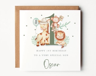 May include: A white card with a green number one surrounded by a giraffe, a monkey, and a lion. The card says "Happy 1st Birthday to a very special son Oscar".