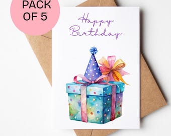 May include: A watercolor birthday card with a blue gift box, party hat, and bow. The card reads "Happy Birthday" in purple script. A pink circle with "PACK OF 5" is in the upper left corner. The card is on a brown envelope.