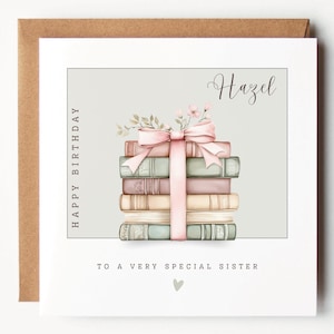 May include: A birthday card with a stack of books tied with a pink ribbon and floral decorations. The card includes the name "Hazel" in script, with the text "Happy Birthday" and "To a very special sister."