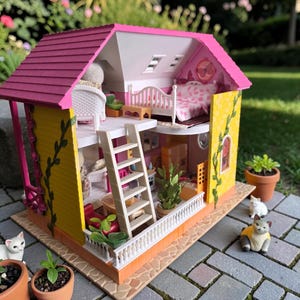 May include: A detailed dollhouse with a pink roof, yellow walls, and a white balcony. The interior features miniature furniture, including a bed, chairs, and a ladder. Small potted plants and toy cats are placed around the dollhouse, creating a charming scene.