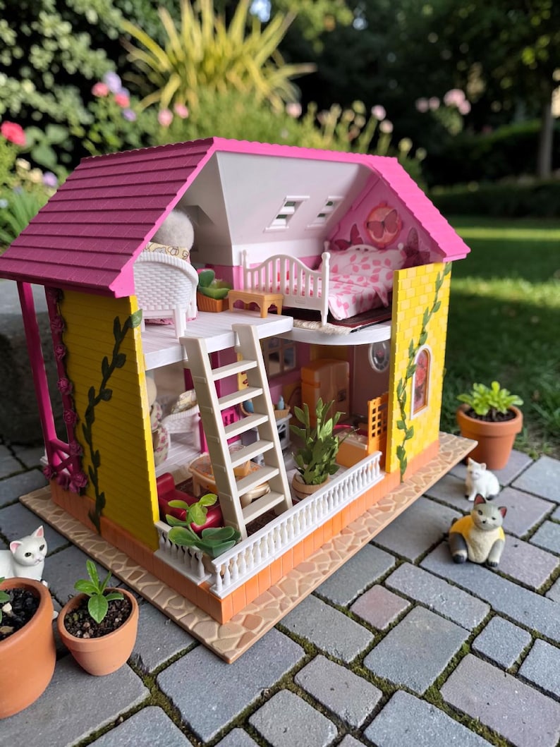 May include: A detailed dollhouse with a pink roof, yellow walls, and a white balcony. The interior features miniature furniture, including a bed, chairs, and a ladder. Small potted plants and toy cats are placed around the dollhouse, creating a charming scene.