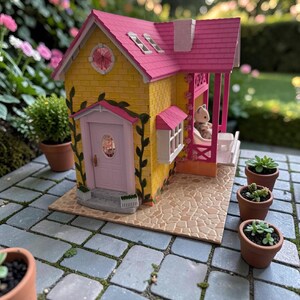 May include: A miniature yellow house with a pink roof, door, and porch. The house has a small porch with a white bench and a doll sitting on it. Several small potted plants are arranged around the house on a stone patio.