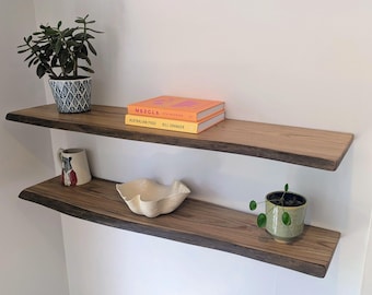 May include: A rustic wooden sign with the text "Welcome to our home" in white lettering. The sign features a distressed finish and a simple, inviting design, perfect for entryway decor.