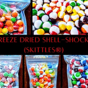 May include: Image of freeze-dried candies in clear plastic bags and scattered on a surface. The candies are colorful, with red, orange, yellow, green, and blue hues. Text on the image reads "FREEZE DRIED SHELL-SHOCKS (SKITTLES®)".