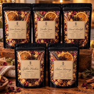 May include: Five black resealable pouches containing dried simmer pot ingredients including orange slices, cinnamon sticks, star anise, and dried botanicals. Each label features the Home by Mavilly logo and specific blend names.