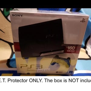 May include: A black Sony PlayStation 3 console with a 160 GB hard drive. The console is in its original box, which is white with red and blue accents. The box also features a picture of a blue and yellow video game controller.