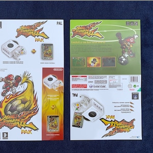May include: A white GameCube console with a white GameCube controller and a copy of the game "Mario Smash Football" for the GameCube. The game is a sports game featuring characters from the Mario franchise. The game is rated 3+ by the PEGI.