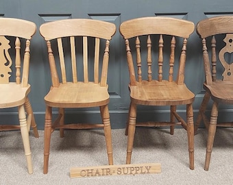 May include: Four wooden chairs with different back designs. The chairs are all made of natural wood and have a light brown finish. The chairs are arranged in a row, with the chair on the left having a simple design, the chair in the middle having a more ornate design, and the chair on the right having a heart-shaped design. The chairs are all in good condition and would be a great addition to any dining room or kitchen.