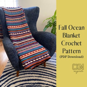 May include: A colorful striped crochet blanket with a textured bobble stitch pattern draped over a blue armchair. The blanket is made with shades of orange, red, purple, teal, and white. The text "Fall Ocean Blanket Crochet Pattern (PDF Download) CXM originals" is displayed on a yellow background.