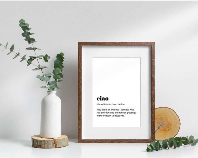 May include: A framed print with a white background and black text. The text reads "ciao" and defines the word as an Italian interjection meaning "hey there" or "bye bye".