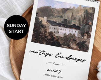 Puede incluir: Un calendario de pared para 2027 con encuadernación en espiral en la parte superior. La portada presenta una pintura al óleo de un gran edificio en un paisaje montañoso. El texto dice "vintage landscapes", "2027" y "WALL CALENDAR". Un círculo negro dice "SUNDAY START".
