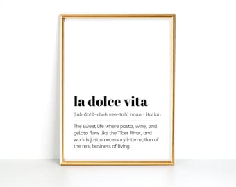 May include: A printable wall art design with a gold frame. The text reads "la dolce vita" with the pronunciation and definition: "[lah dohl-cheh vee-tah] noun * italian The sweet life where pasta, wine, and gelato flow like the Tiber River, and work is just a necessary interruption of the real business of living."
