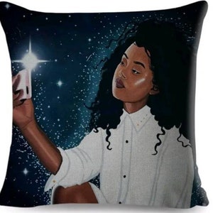 Black teenager girl cushion using her mobile phone.