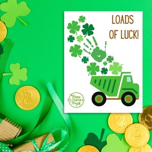 May include: A green dump truck with a handprint and shamrocks pouring out of the back. The truck is on a white card with the text "Loads of Luck!" and "Happy St. Patrick's Day".
