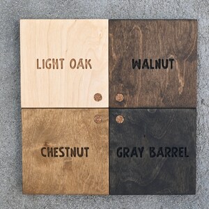 May include: Four wood samples with different stain colours: Light Oak, Walnut, Chestnut, and Grey Barrel. Each sample has a small cork circle in the top right corner.