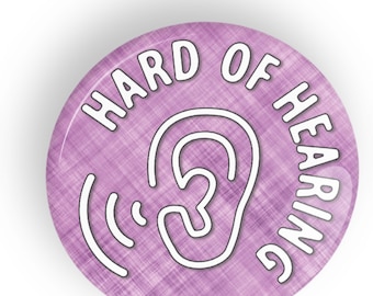 May include: Purple button with a white outline of an ear and sound waves. The text "HARD OF HEARING" is written around the ear in a white outline.