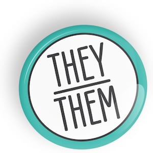 May include: A teal blue button with a white background and the text "THEY/THEM" in black.