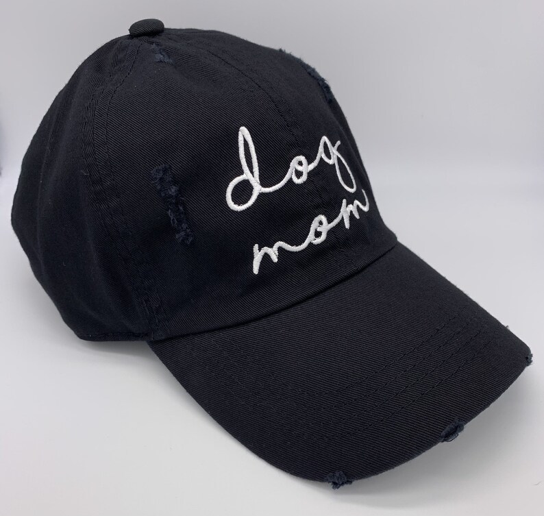 May include: A black baseball cap with a white embroidered design that says "dog mom".