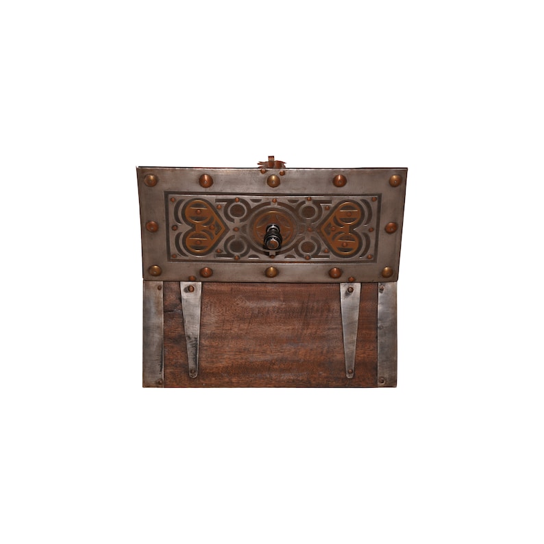 May include: A wooden box with a metal lid. The lid has a decorative design with brass accents and a metal knob. The box is closed.