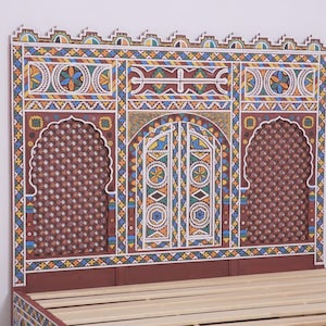 May include: A decorative headboard with a detailed, colourful design. The headboard features a central arched door design flanked by two arched windows. The colour palette includes red, blue, yellow, and white. The bed frame is made of wood.