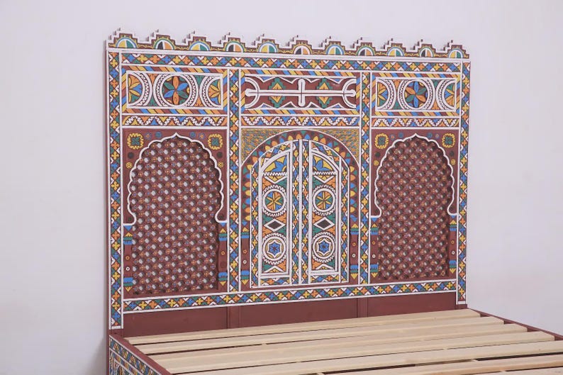 May include: A decorative headboard with a detailed, colourful design. The headboard features a central arched door design flanked by two arched windows. The colour palette includes red, blue, yellow, and white. The bed frame is made of wood.