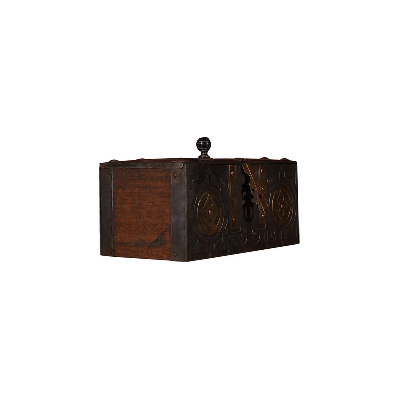 May include: A wooden box with metal accents and a decorative brass design. The box has a hinged lid with a black knob.