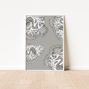 May include: A gray and white watercolor print with a quote about pottery and faith. The quote reads "But now, LORD, You are our Father. We are all the work of Your hand. We are the clay. You are the Potter."