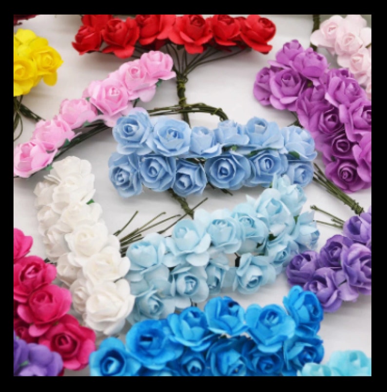 Puede incluir: Surtido de cabezas de flores de papel en varios colores, incluyendo rojo, rosa, blanco, azul claro, azul y morado. Las flores est&aacute;n dispuestas en racimos y tienen un aspecto delicado y realista.