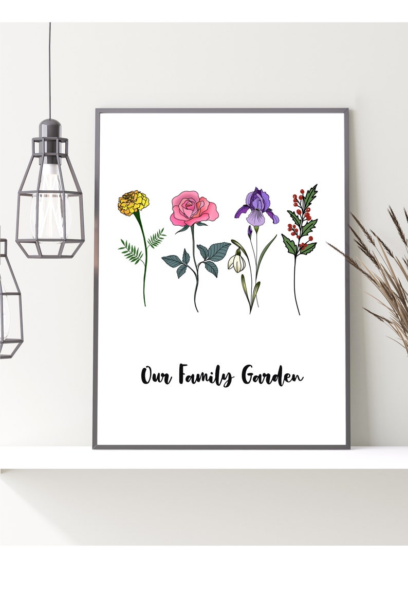 May include: Framed art print featuring botanical illustrations of various flowers, including a yellow marigold, a pink rose, a purple iris, and red berries. The words "Our Family Garden" are written in a script font.