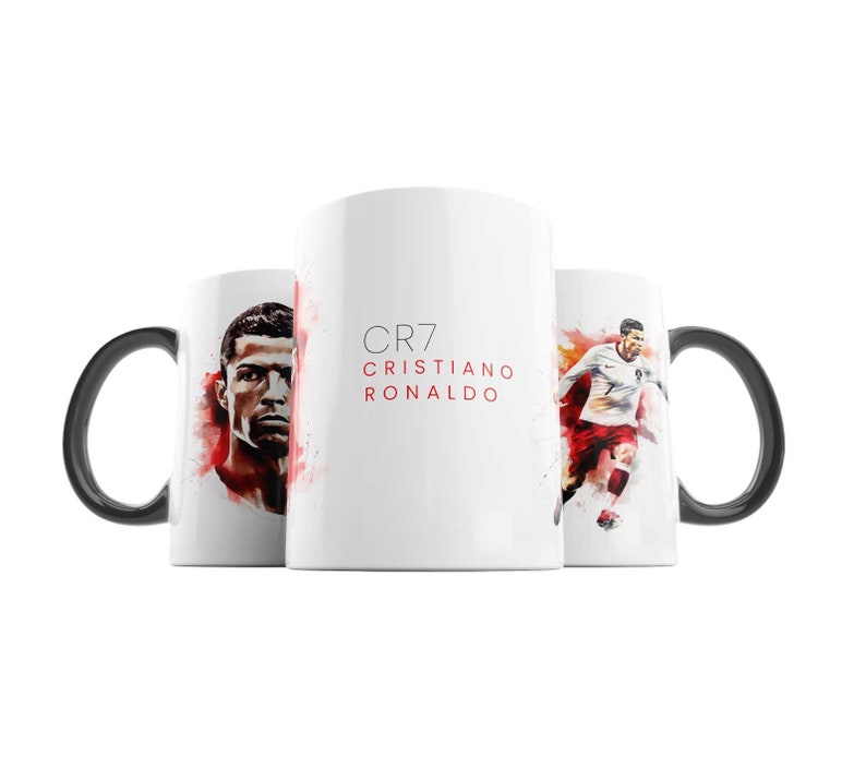 May include: White ceramic mug with a black handle. The mug features a watercolour illustration of Cristiano Ronaldo, a football player, with the text "CR7 CRISTIANO RONALDO" printed on the front.