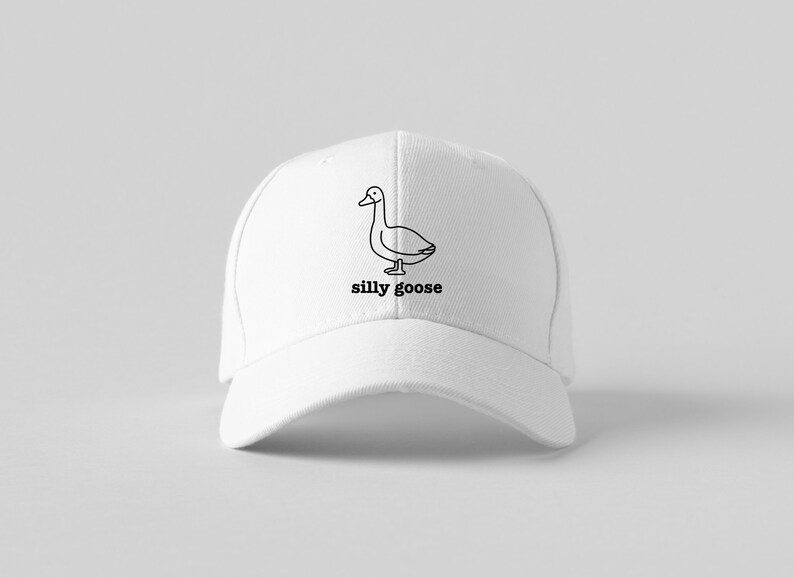 May include: White baseball cap with a black line drawing of a goose and the text "silly goose" embroidered on the front.