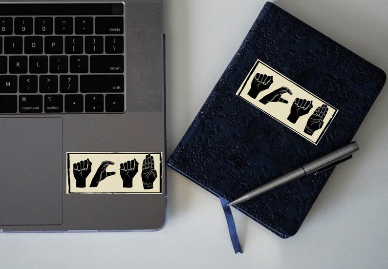 Close-up of ACAB hand signs vinyl sticker texture showing fine matte laminated finish.