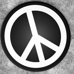 May include: A black and white peace sign button. The peace sign is a white circle with a black symbol inside.