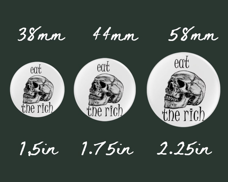 May include: Three white round buttons with a black and white skull graphic and the text "eat the rich". The buttons are 1.5 inches, 1.75 inches, and 2.25 inches in diameter.
