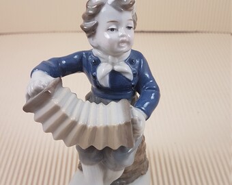 Vintage victorian boy playing harmonica porcelain figurine made in Germany