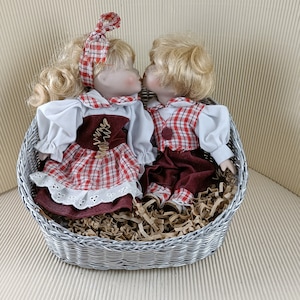 Vintage porcelain pair of dolls collectible boy and girl sitting in basket
