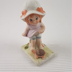 Vintage little baby girl with turtle figurine porcelain