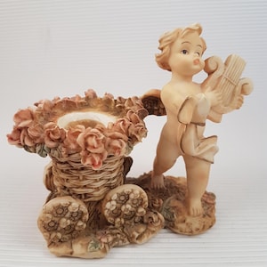 Vintage candlestick with cherub baby angel