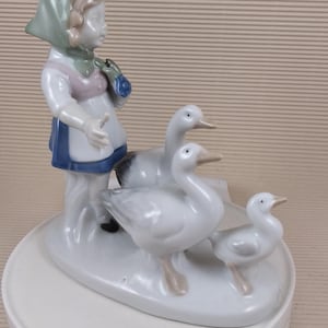 Vintage porcelain girl with geese figurine made in mid century Germany