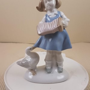 Vintage porcelain girl with goose figurine made in mid century Germany
