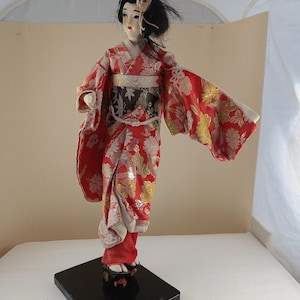 Antique japan geisha textile doll on wooden stand