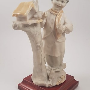 Italian Bruno Merli Capodimonte porcelain figurine of girl feeding birds, signed and stamped