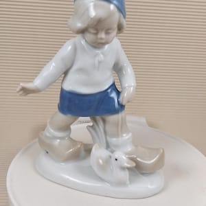 Vintage little baby girl with goose and figurine porcelain
