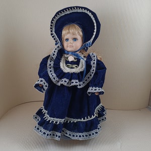 Vintage old lovely bisque porcelain doll collectible medium size blond haired with bonnet