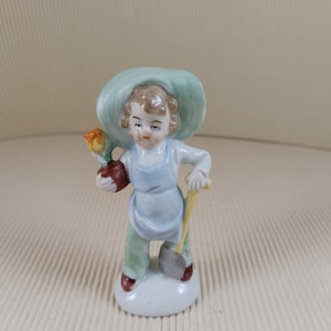 Vintage antique little boy in the garden figurine