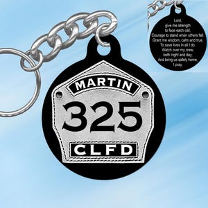 May include: Black and silver firefighter keychain with the text "MARTIN 325 CLFD" and a prayer for firefighters on the back.