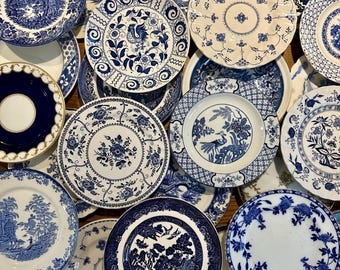 Puede incluir: Una colección de platos de cerámica azul y blanco con varios patrones florales y geométricos. Los platos están dispuestos en una pila, con algunos superpuestos.