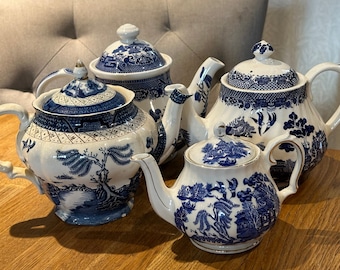 May include: Four blue and white teapots with a traditional willow pattern. The teapots are made of ceramic and have a glossy finish.